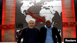 FILE—Pierre Guillon de Prince, whose ancestors owned ships transporting enslaved people, and Dieudonne Boutrin, a descendant of enslaved Africans in Martinique, president of a group that campaigns on slavery and reparations, in Nantes, France, March 23, 2024.