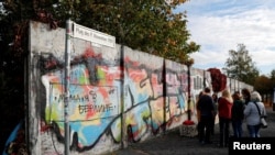 FILE - Remains of the Berlin Wall at the former Bornholmer Strasse Berlin Wall border crossing point, Oct. 18, 2019. On November 9th Germany will mark the 30th anniversary of the fall of the Berlin Wall.