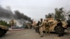 FILE - Afghan security forces keep watch at the site of an explosion in Jalalabad city, Afghanistan, May 13, 2018. On Friday three explosions rocked a cricket stadium.