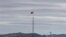 FILE - A North Korean flag flutters in the wind atop a tower in North Korea's village of Gijungdongseen, as seen from the Taesungdong freedom village inside the demilitarized zone in Paju, South Korea, April 27, 2018. 