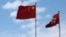 A Chinese national flag and a Hong Kong flag fly outside the Legislative Council in Hong Kong, China November 7, 2016, as China's parliament passed an interpretation of Hong Kong's Basic Law on Monday that says lawmakers must swear allegiance to the city 