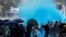 Protesters are sprayed with blue liquid from water cannon during clashes with police outside Hong Kong Polytechnic University in Hong Kong, Nov. 17, 2019.