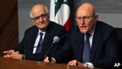 Lebanese Prime Minister Tammam Salam, right, speaks as Lebanese Information Minister Ramzi Jreij, left, listens during a press conference at the government House in Beirut, Lebanon, Feb. 22, 2016.