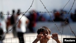 A child is seen at the new temporary camp for migrants and refugees, on the island of Lesbos, Greece.