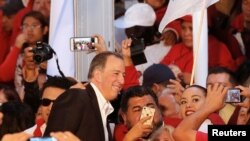 FILE - Jose Antonio Meade, former Mexico Finance Minister, poses for selfies with his supporters after registering as a presidential pre-candidate for the Institutional Revolutionary Party (PRI), in Mexico City, Mexico, Dec. 3, 2017.