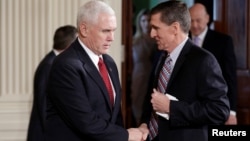 Vice President Mike Pence greets National Security Advisor Michael Flynn before Japanese Prime Minister Shinzo Abe and U.S. President Donald Trump arrive for their joint news conference at the White House in Washington, Feb. 10, 2017.