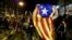 Demonstrators celebrate after police leave the area during a protest after a verdict in a trial over a banned independence referendum in Barcelona, Spain, Oct. 20, 2019. 
