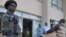 Togolese police forces stand guard at gate as electoral Commission members arrives with the ballot result papers on March 6, 2010 in Lome ahead of an election results announcement.