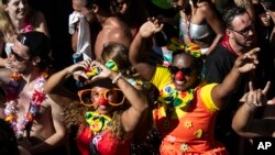 Revelers dressed as clowns dance during the Carmelitas street party on the first day of Carnival in Rio de Janeiro, Brazil, February 9, 2024.