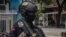 An Indonesian policeman stands guard at the site of an explosion outside a church in Makassar on March 28, 2021. (Photo by INDRA ABRIYANTO / AFP)