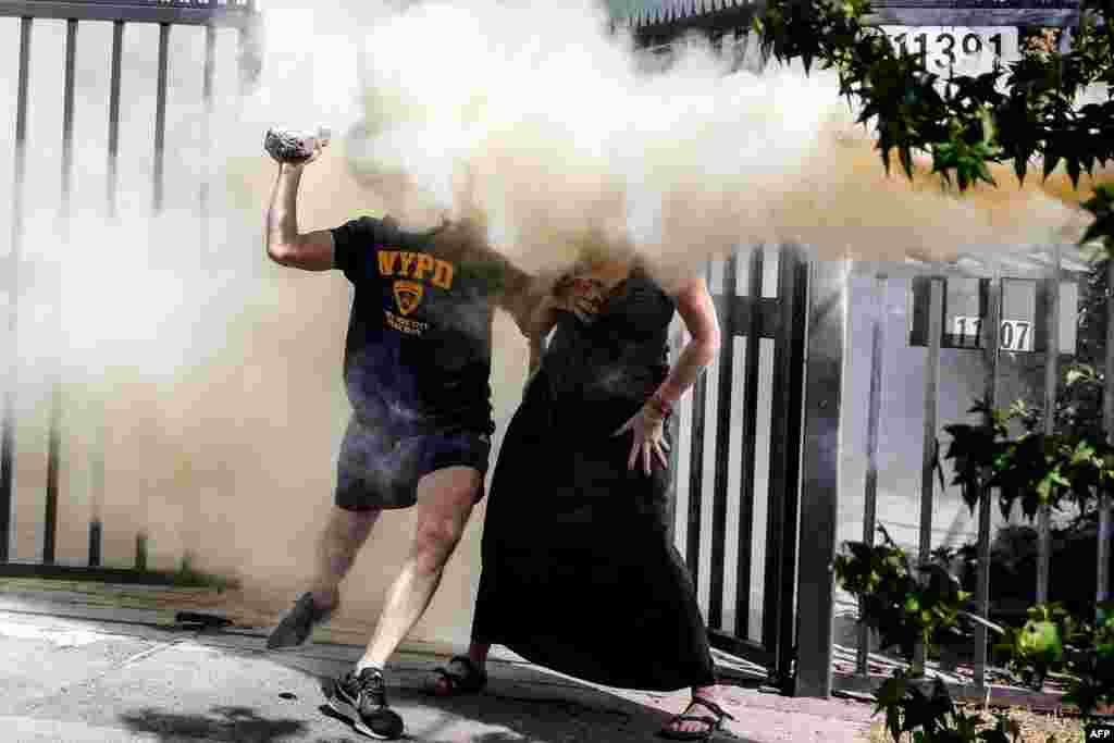 Neighbors of the Chilean President Sebastian Pinera are sprayed with a fire extinguisher by protesters near Pinera&#39;s house in Santiago, Dec. 1, 2019.