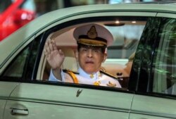 Thailand's King Maha Vajiralongkorn waves from his limousine after officiating a graduation ceremony at Thammasat University in Bangkok, Thailand, Oct. 31, 2020.