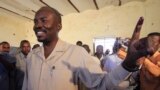 FILE - Then-National Congress Party candidate for governor, Ahmed Haroun, shows off the marking on his finger after voting at a polling center in Kadogli in Sudan's South Kordofan state, May 2, 2011. 