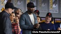 Mahershala Ali, center, wears a hat to promote his new movie "Blade" at the Marvel Studios panel on day three of Comic-Con International on July 20, 2019, in San Diego. 