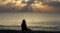 FILE - A woman meditates on the beach in Miami, Florida, April 28, 2010. According to a study published on Nov. 9, 2022 in the journal JAMA Psychiatry, mindfulness meditation worked as well as a standard drug for treating anxiety. (AP Photo/Lynne Sladky, File)