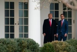 President Donald Trump and Venezuelan opposition leader Juan Guaido walk to a meeting in the Oval Office of the White House, Feb. 5, 2020.
