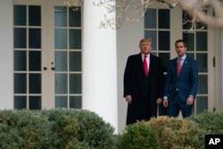 President Donald Trump and Venezuelan opposition leader Juan Guaido walk to a meeting in the Oval Office of the White House, Feb. 5, 2020.