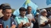 Crimean Tatars pray as they block the road at the checkpoint between continental Ukraine and occupied Crimea, in Chongar, September 20, 2015. (Genya Savilov/AFP)