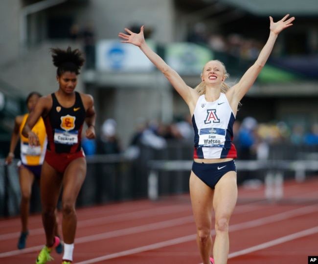 FILE - Arizona's Sage Watson, right, raises her arms in victory as she defeated Southern California's Anna Cockrell to win the women's 400 hurdles during the NCAA outdoor college track and field championships in Eugene, Ore., Saturday, June 10, 2017. (AP Photo/Timothy J. Gonzalez)