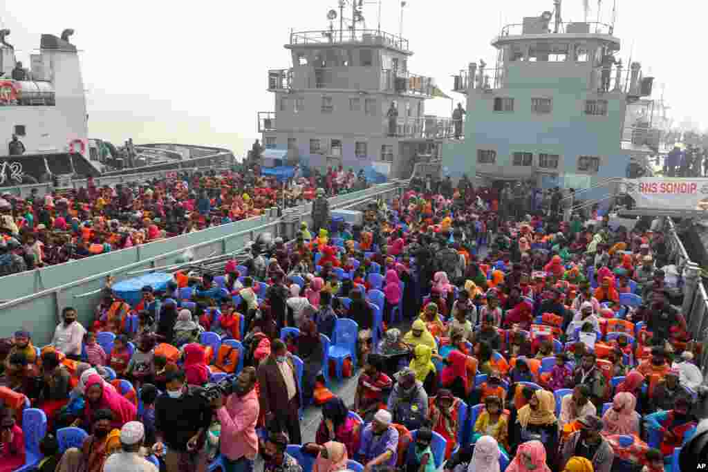 Rohingya refugees headed to the Bhasan Char island board navy vessels from the south eastern port city of Chattogram, Bangladesh.