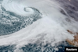 A low-pressure storm system known as a "bomb cyclone" forms off the coast of the U.S. Pacific Northwest and western Canada in this composite satellite image made Nov. 19, 2024. (NOAA via Reuters)