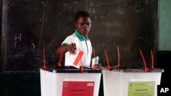 A man casts his vote during the first round of presidential elections in Monrovia, Liberia, Oct. 10, 2017.