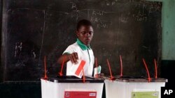 FILE - A man cast his vote during the first round of presidential elections in Monrovia, Liberia, Oct. 10, 2017.