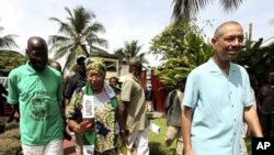 Liberian President and presidential candidate of the Unity Party (UP) Ellen Johnson-Sirleaf walks at her residence in Monrovia October 7, 2011.