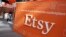 FILE - A sign advertising the online seller Etsy Inc. is seen outside the Nasdaq market site in Times Square, April 16, 2015.