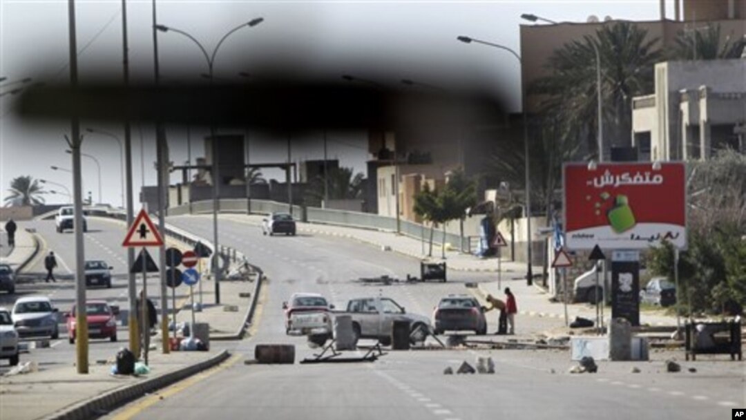 An impromptu roadblock is seen through a car windscreen in Tripoli, Libya, February 26, 2011