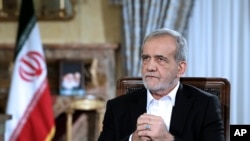 FILE - In this photo released by the Iranian Presidency Office, President Masoud Pezeshkian speaks in a live televised interview by state TV, at his office in Tehran, Iran, Aug. 31, 2024. 