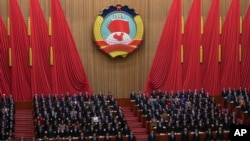 Leaders and delegates stand as they sing the national anthem during the opening session of the Chinese People's Political Consultative Conference at the Great Hall of the People in Beijing, March 4, 2025. 