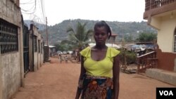 Isatu Gbankay, six months pregnant, stands outside a friend's home in Freetown, Sierra Leone, April 8, 2015. (Nina deVries/VOA)