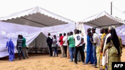 Voters line up prior to casting their vote in Senegal's legislative election, July 30, 2017, in Dakar. 