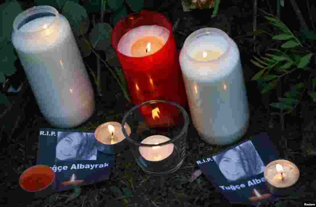 Lit candles and images of Tugce Albayrak are seen at her grave in Bad Soden-Salmuenster, Dec. 3, 2014.