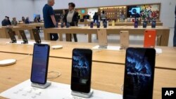 A selection of iPhones are displayed an Apple store, Jan. 28, 2020, in suburban Boston. 