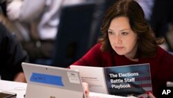 Mandy Vigil of New Mexico works during an exercise run by military and national security officials, for state and local election officials to simulate different scenarios for the 2020 elections, in Springfield, Va., Dec. 16, 2019.