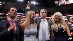 Republican Presidential Candidate Donald Trump's children Donald Trump, Jr., Ivanka Trump, Eric Trump AND Tiffany Trump celebrate on the convention floor during the second day session of the Republican National Convention in Cleveland, July 19, 2016. 