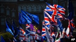 EU and Union flags flap outside the Houses of Parliament in London, Monday, Oct. 28, 2019. European Council president Donald Tusk says the bloc has agreed to grant Britain a new Brexit delay to Jan. 31 next year. 