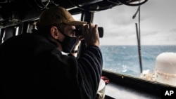 Trong ảnh do Hải quân Hoa Kỳ cung cấp: Ensign Grayson Sigler quan sát đường chân trời trong khi đứng trên tàu khu trục tên lửa dẫn đường USS John S. McCain đang đi qua eo biển Đài Loan, ngày 30/12/2020. 