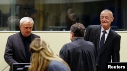 Jovica Stanisic and Franko Simatovic appear in court for their retrial at the United Nations Mechanism for International Criminal Tribunals in The Hague on June 13, 2017.