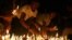 Protesters hold candles during a candlelight vigil at Sule Pagoda in Rangoon, Burma, May 23, 2012. 