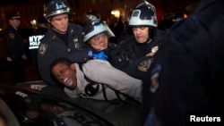 New York Police Department (NYPD) officers arrest a young man during a protest against the killing of 16-year-old Kimani "Kiki" Gray who was killed in a shooting involving the NYPD, in the Brooklyn borough of New York Mar. 13, 2013.