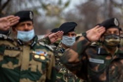 FILE - India Border Security Force soldiers salute as they pay respect to their colleague killed during a recent clash with Pakistani soldiers in Kashmir, Nov. 15, 2020.