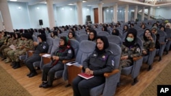 Afghan women police officers attend an event to mark International Women's Day in Kabul, Afghanistan, March 7, 2021. 