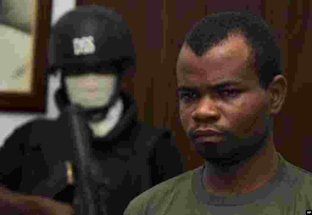 Kabiru Sokoto, a suspect in a Christmas Day bomb attack of St. Theresa Catholic Church in Madalla near Nigeria's capital, is guarded by a security official inside the state security service office in the capital Abuja February 10, 2012.