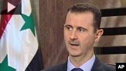 A Free Syrian Army fighter takes a position as he aims his weapon at the Justice Palace, which is controlled by forces loyal to Syria's President Bashar al-Assad, in Aleppo. 