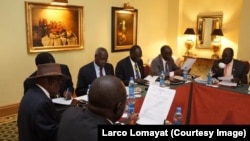 Negotiators at South Sudan peace talks in Addis Ababa review a draft cessation of hostilities agreement on Jan. 13, 2014.