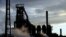 FILE - One of the blast furnaces of the Tata Steel plant is seen at sunset in Port Talbot, South Wales, May 31, 2013. 