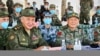 Russian Defense Minister Sergei Shoigu, L, and Chinese Defense Minister Wei Fenghe watch a joint military exercise held in the Ningxia Hui Autonomous Region in northwestern China, Aug. 13, 2021. (Russian Defense Ministry Press Service/Handout)